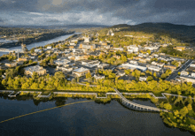 an aerial view of a small town with a bridge over a lake