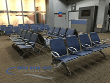 a waiting area with blue chairs and a sign that says " gate 9 "