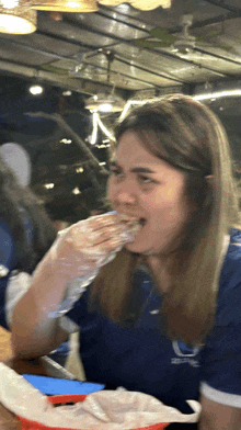 a woman in a blue shirt with the letter c on it