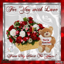 a teddy bear sits next to a basket of red and white roses