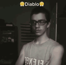 a man wearing glasses and a tank top that says 13x13