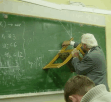 a man is using a chair to solve a math problem on a blackboard ..