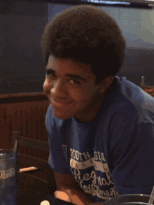 a young man wearing a blue shirt that says youth basketball