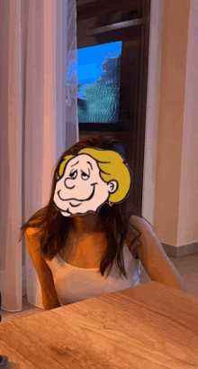 a woman with a yellow cartoon face on her face