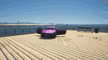 a pink car is parked on a wooden deck