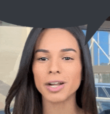 a close up of a woman 's face with a speech bubble over her head