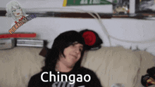 a person is laying on a couch and the word chingao is visible