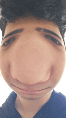 a close up of a man 's face with a very large nose