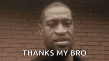 a man in front of a brick wall says " thanks my bro "