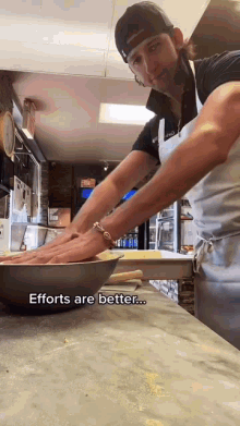 a man in an apron is kneading dough in a bowl with the words efforts are better written on the bottom