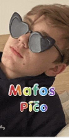 a man wearing heart shaped sunglasses with the words mafos pico written on the bottom