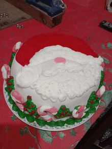 a santa cake with candy canes and holly