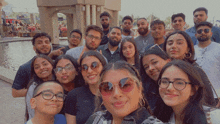 a group of people posing for a picture with one wearing sunglasses and a shirt that says calvin klein