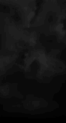 a black background with white clouds in it