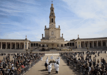 a crowd of people gathered in front of a large building