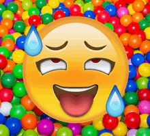 a smiley face is surrounded by colorful balls and sweating