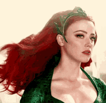 a woman with red hair and a green dress