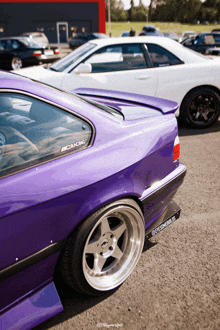 a purple car with a sticker on the window that says ecracing