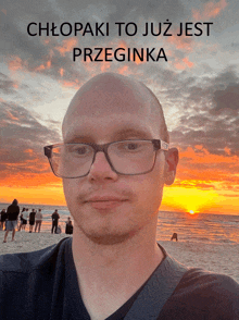 a bald man wearing glasses stands in front of a sunset with the words chłopaki to już jest przegina on the top