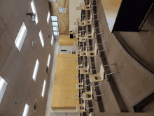 a row of empty chairs in a classroom with a projector on the wall