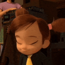 a little girl from the boss baby cartoon is smiling with her eyes closed and wearing a suit and tie .