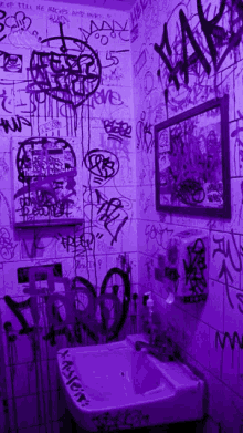 a bathroom with graffiti on the walls and a sink