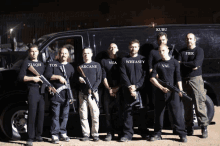 a group of men standing in front of a van wearing shirts that say arcane yua and wheasey