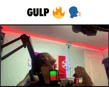 a video of a man talking into a microphone with the word gulp above him