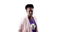 a woman wearing a purple shirt and a pink cardigan is looking at the camera .