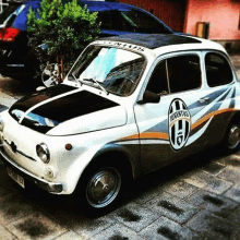 a juventus car is parked on a sidewalk