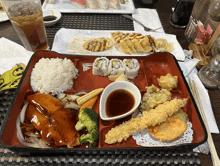 a bento box filled with a variety of food including sushi