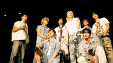 a group of young men are posing for a picture and one of them has a shirt that says first love