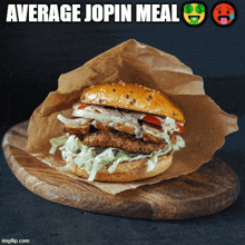 a hamburger on a wooden cutting board with average jopin meal written on the bottom