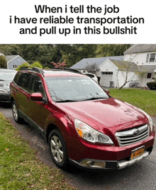 a red suv is parked in front of a house