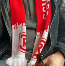 a man wearing a red and white scarf that says ' ss ' on it