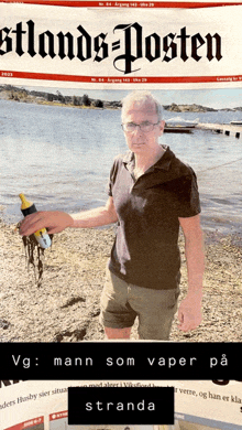 a man is holding a bottle in front of a newspaper that says stranda on it