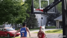 a man in a blue jersey with the number 3 is playing basketball with another man in a red jersey with the number 31 .