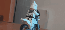 a lego clone trooper is riding a dirt bike with the number 11 on the back