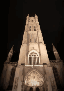 a church with a very tall tower and a very large window