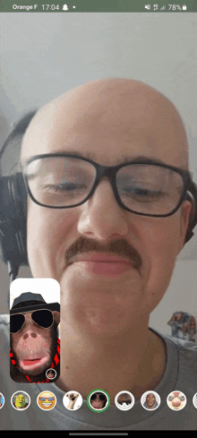 a man with glasses and a mustache is on a phone screen