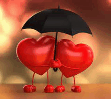 two red hearts are holding an umbrella .