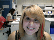 a woman sitting at a desk with a sticker on it that says ' uc san diego '