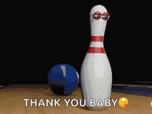 a bowling pin with googly eyes says thank you baby next to a bowling ball