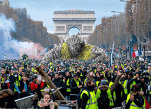 a crowd of people are gathered in front of a large archway