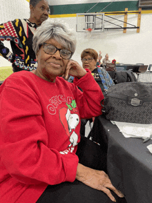 a woman wearing a red sweater that says ho ho ho