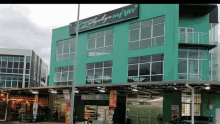 a green building with a sign that says ' zalyan mart ' on it