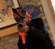 a man wearing a mask and holding a toy gun