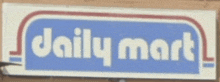 a daily mart sign that is on a brick wall