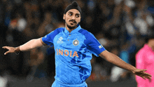 a man wearing a blue shirt that says india