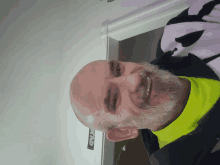 a man with a beard is smiling in front of a bread sign